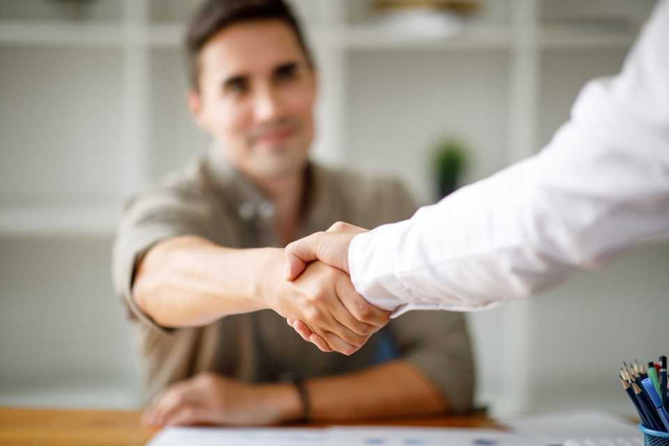 Businessmen shake hands to close a deal