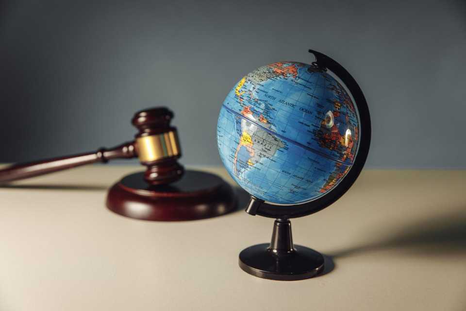 hiring lawyer to sue someone located abroad