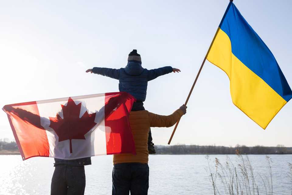 Family with canadian ukranian flags