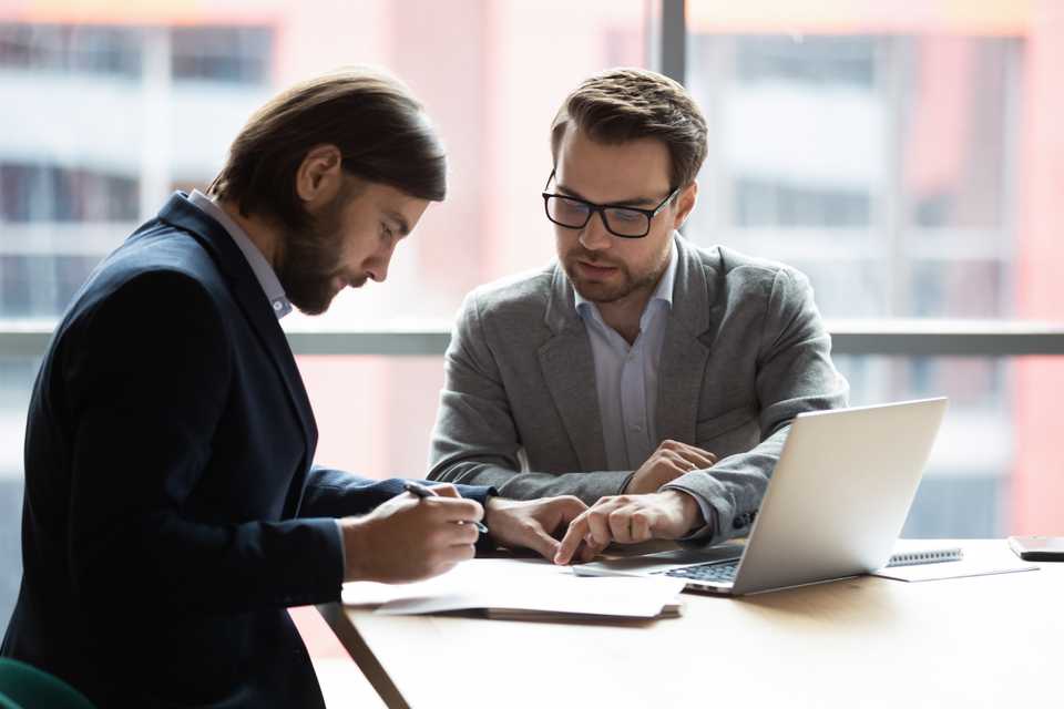 skilled real estate lawyer guiding his client with the paperwork