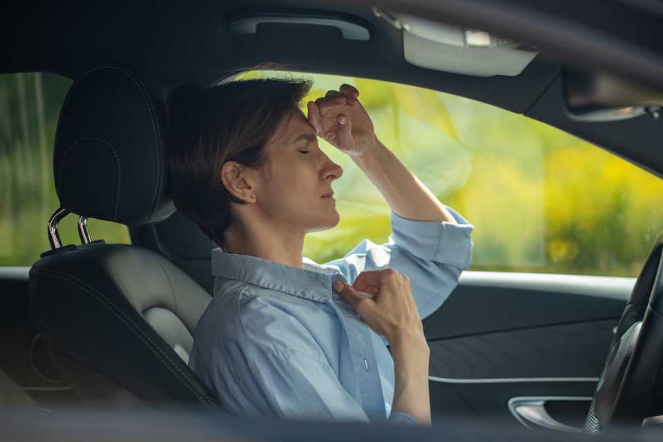 female driver feeling ill while behind the wheel