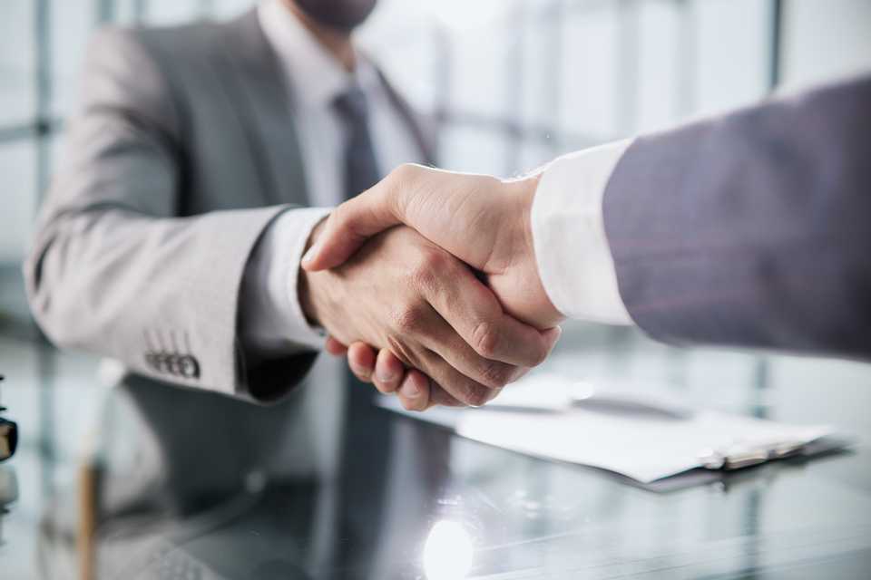 lawyer shaking hands with client after consultation