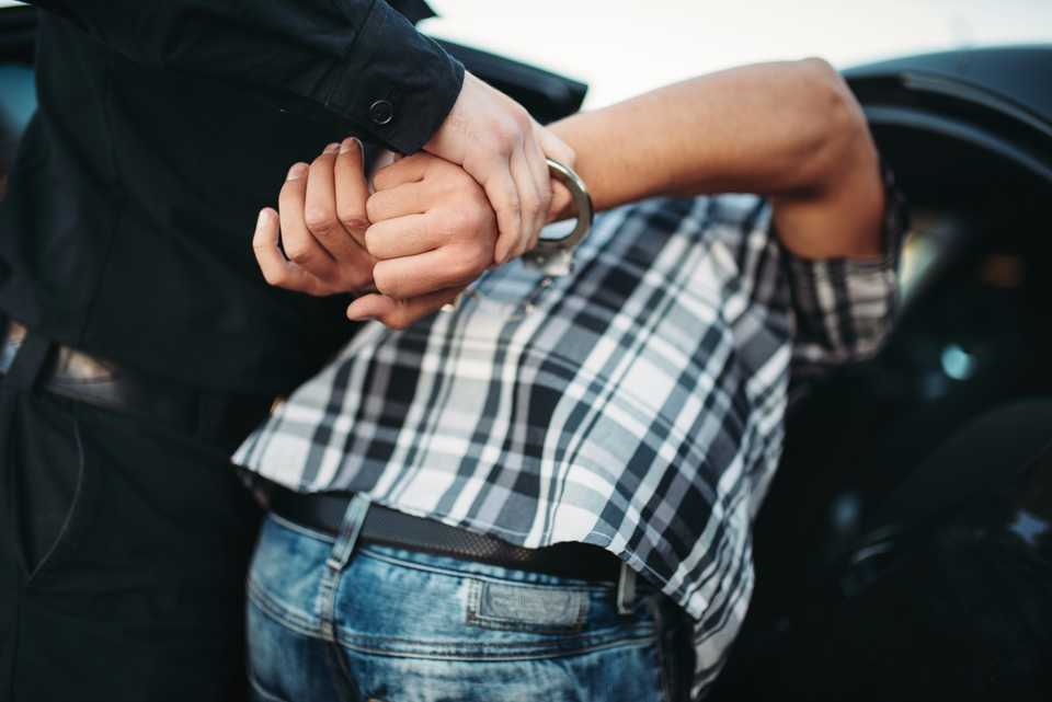 man in handcuffs for serious driving violations