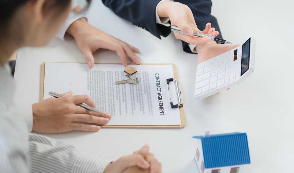 homebuyers signing purchase agreement for a new home