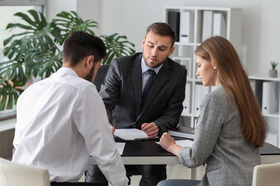 Couple in negotiation with a lawyer for child custody. couple in negotiation with a lawyer for child custody