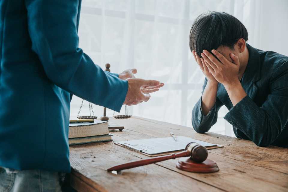 client in distress consulting with a lawyer