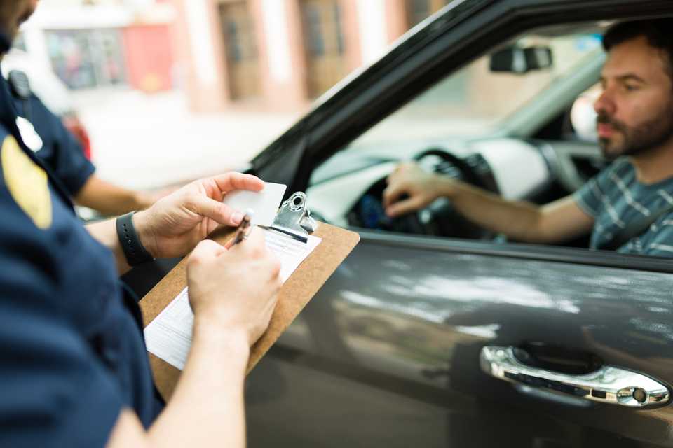 police officer issuing ticket to driver