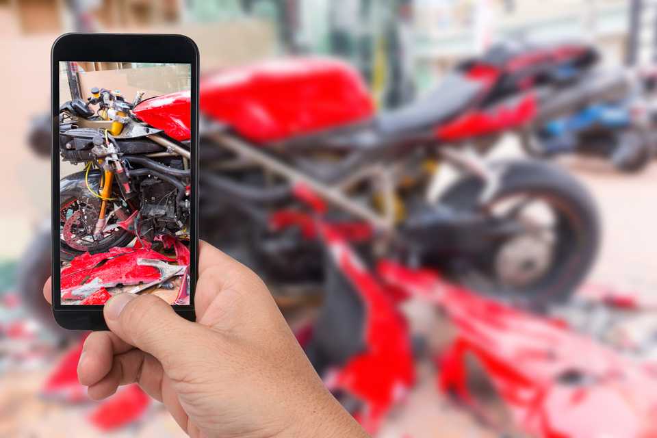 scene of motorcycle accident being recorded on smartphone